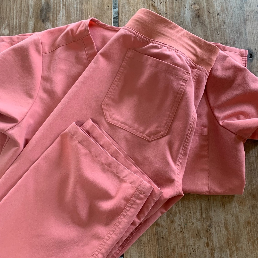 Size small Figs scrubs in pink. Small stain above pocket- see pictures.